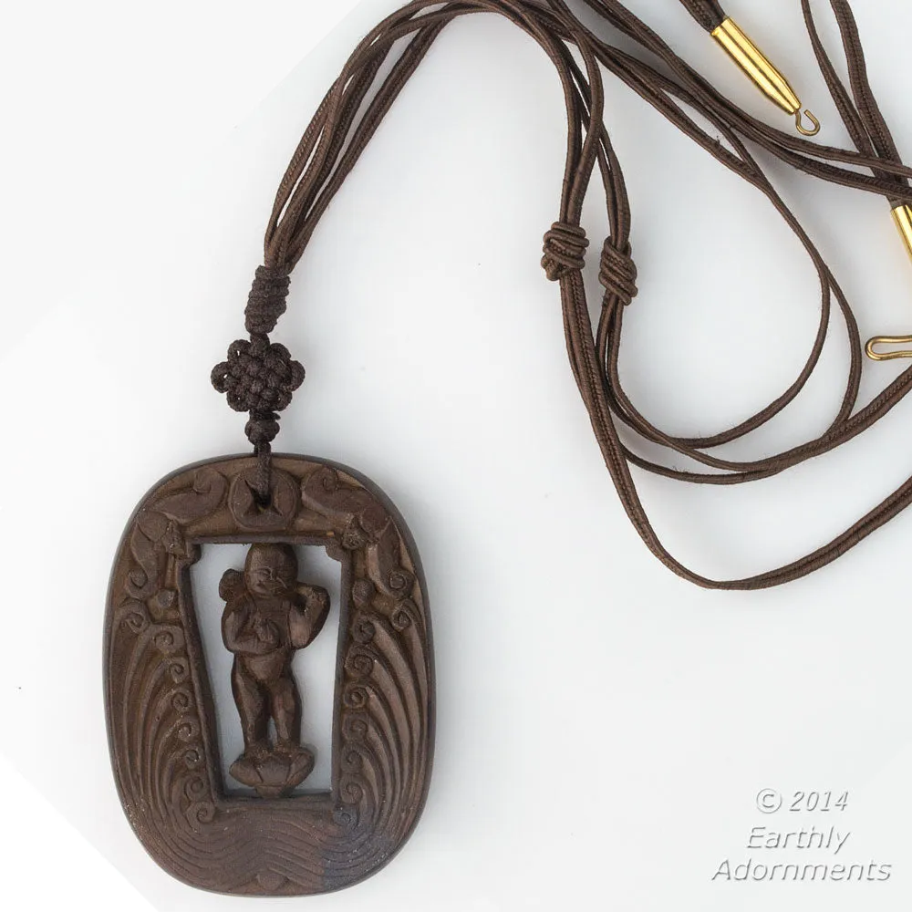 Vintage Chinese carved wood swiveling deity with two bats descending from heaven pendant. pdwd101